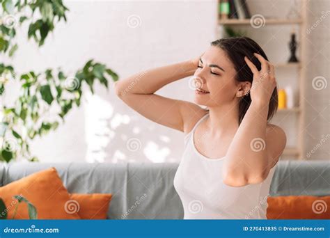 Lady Sitting On The Couch Gives Herself A Head Massage Stock Image