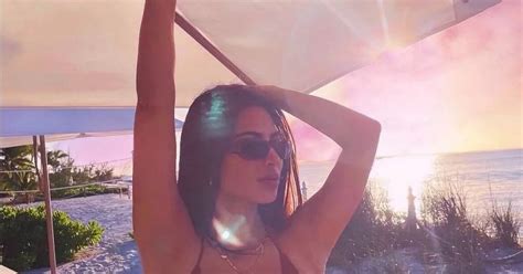 Kim Kardashian S Cleavage Spills Out Of Tiny String Bikini Amid Kanye