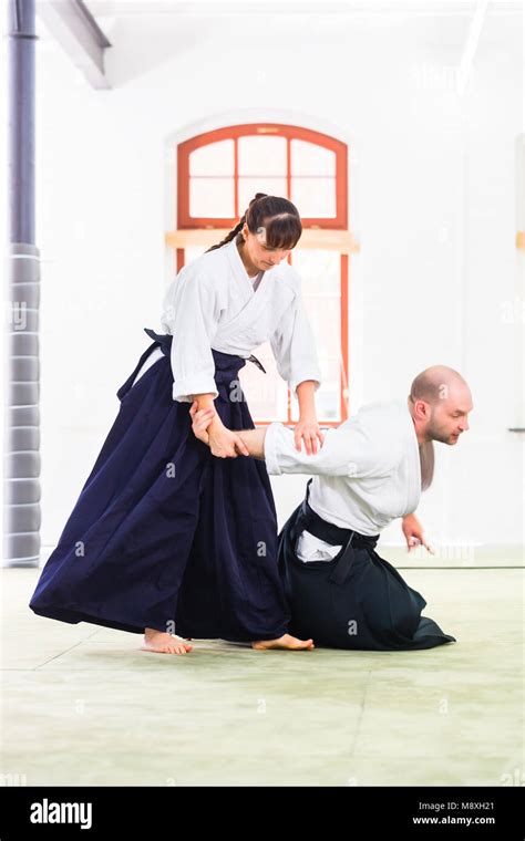 Man and woman fighting at Aikido martial arts school Stock Photo - Alamy