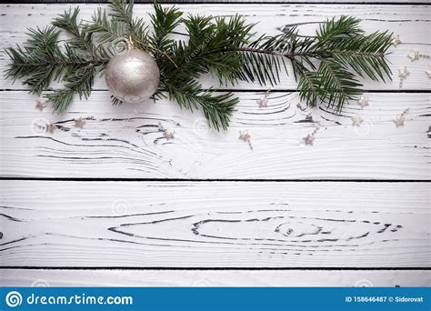 Green Fir Tree Twigs Decorated With A Christmas Ball Form A Border At