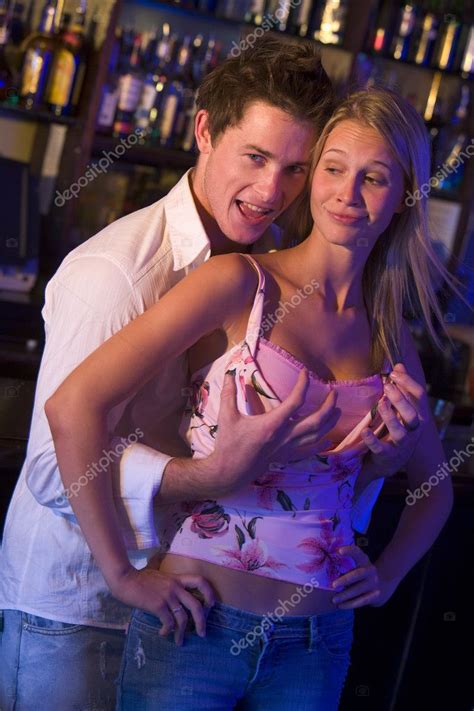 Young Man In A Nightclub Grabbing Young Womens Breasts From Beh — Stock