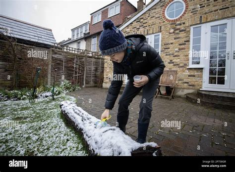 London, England, UK 8th March 2023, A young boy collecting snow after a ...