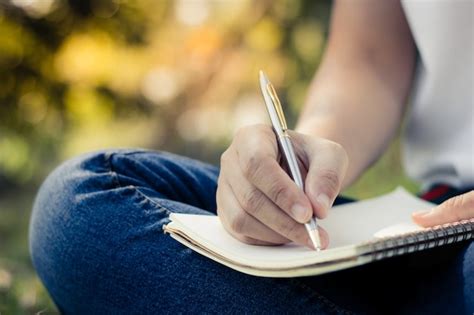 Mujeres jóvenes escribiendo en el cuaderno en el parque la educación y