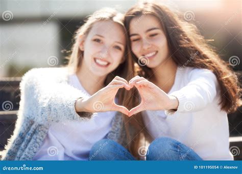 Two Girls Holding Hands In Shape Of Heart Stock Photography