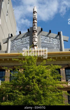 Totem pole and longhouse on top of Skwachays Lodge hotel and art ...