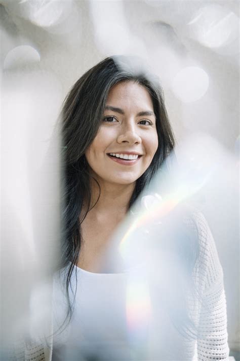 Gay Couple Embracing And Kissing Underneath The Rainbow Flag Authentic Stock Photos