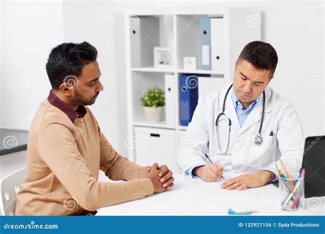 Doctor And Male Patient Meeting At Clinic Stock Photo Image Of