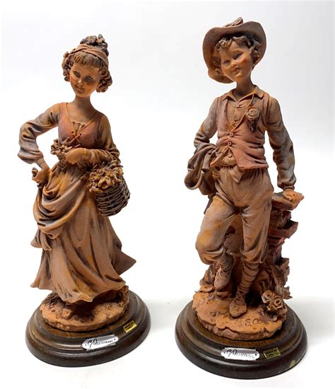 Lot Two Giuseppe Armani Figures Of A Boy And Girl On Timber Stands