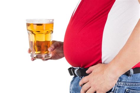 Premium Photo Midsection Of Person Holding Beer Glass Against White