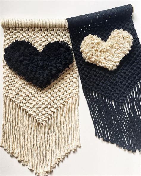 Two Black And White Heart Shaped Rugs Hanging On A Wall