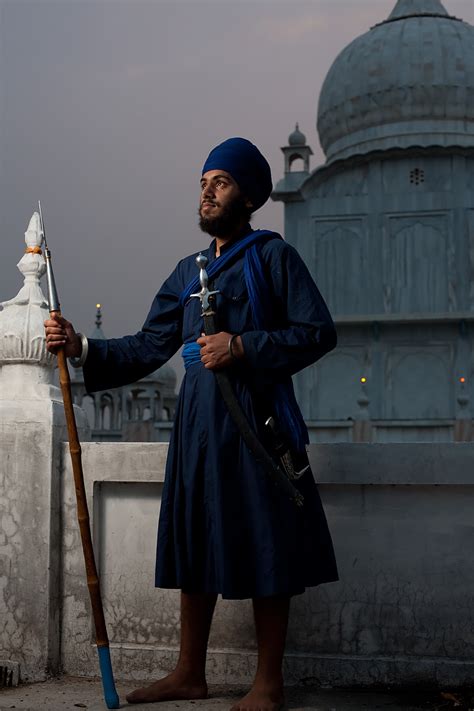 Ornamental Dagger - A Sikh man holds a spear, sword and dagger at the