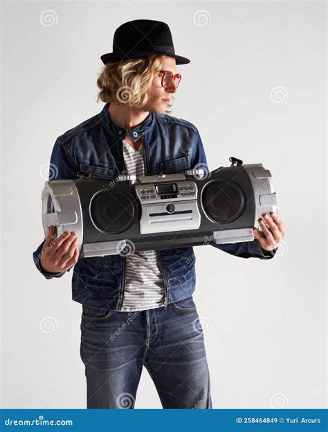 The Sounds Of A Boombox Studio Shot Of A Handsome Young Man Holding A