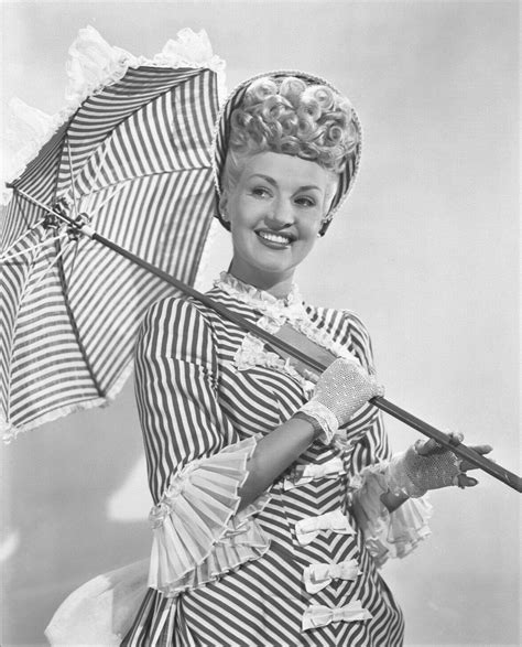 Betty Grable Wearing A Striped And Ruffled And Bow Bedecked Confection