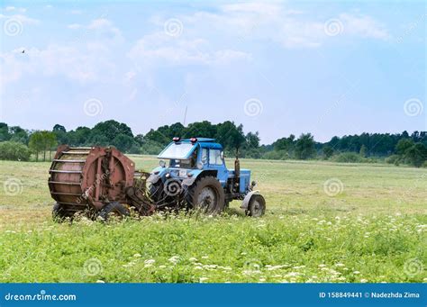 Tractor Bale Hay In Field Blue Tractor To Collect Hay In Bales