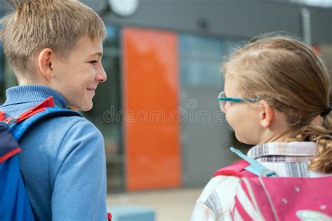 Two Happy School Children Walking and Talking in Campus before Lessons ...