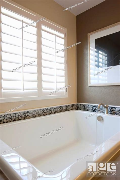 Bathtub by window in master bathroom, Stock Photo, Picture And Royalty ...