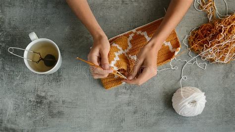 Womans Hands Peeling A Clementine Orange Top View On Marble Table