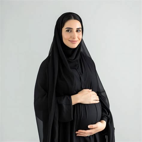 Premium Photo A Pregnant Woman Embracing Her Belly Wearing A Black