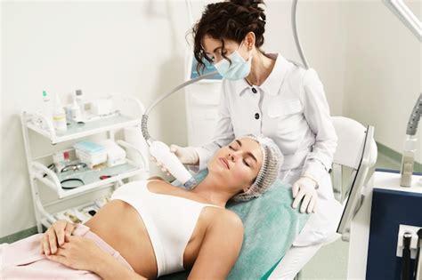 Premium Photo Doctor And Beautiful Woman Client During Radiofrequency