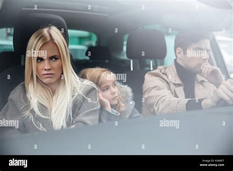 Picture of angry displeased young family sitting in car after quarrel ...