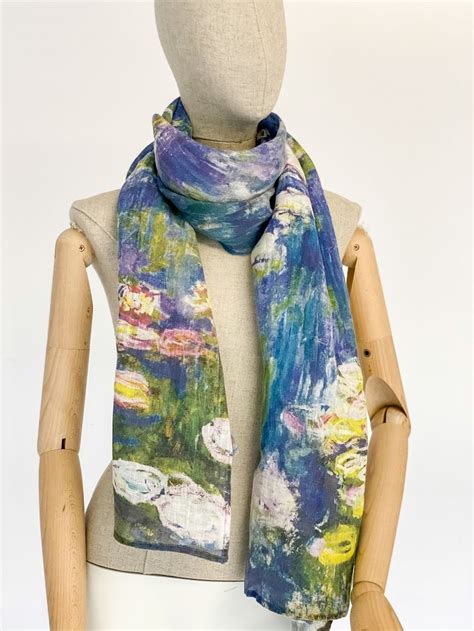 A Mannequin Wearing A Scarf With Water Lilies On It