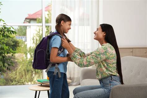 Mother Saying Goodbye To Her Daughter Before School At Home Stock Image