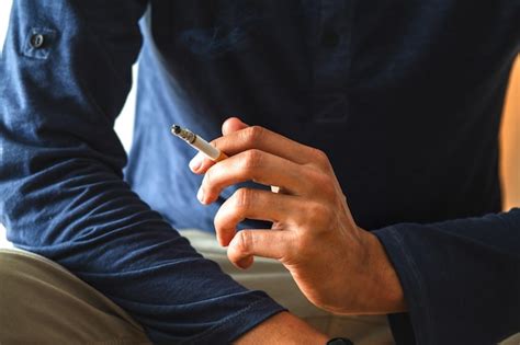 Premium Photo Close Up Of Man Smoking Cigarette