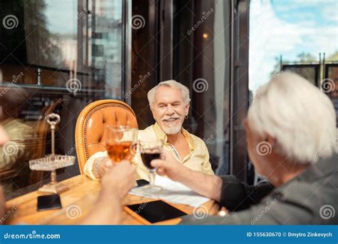 Men Celebrating Their Retirement While Drinking Alcohol Stock Photo