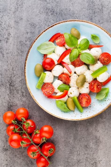 Delicious Caprese Salad With Ripe Cherry Tomatoes And Mini Mozzarella