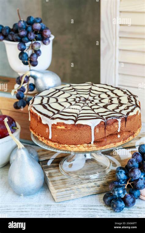 Halloween Chocolate Spider Web Cake And Various Fruits Around Party