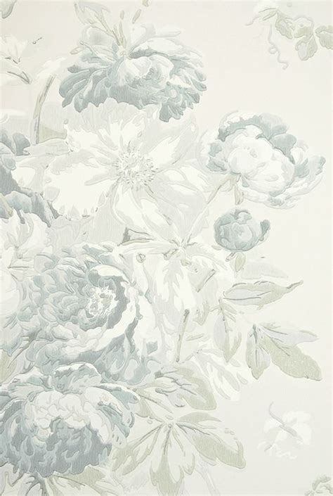 A White And Blue Wallpaper With Flowers On It