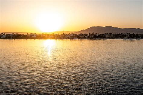 View of the Nile River with Sailboats at Golden Colorful Sunset in Luxor, Egypt Stock Photo ...