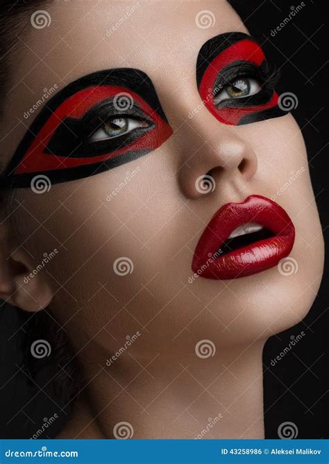 Red Lips Black Makeup On The Eyes Of The Mask Women Beauty Stock Photo ...