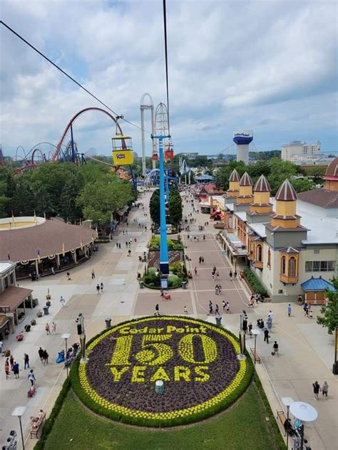 An Aerial View Of The Amusement Park With People Walking Around