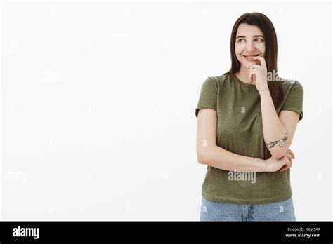 Dreamy And Sensual Cute Ordinary Brunette Female With Tattoo And Brown Eyes Smiling Tenderly And