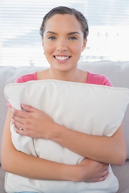 Premium Photo Happy Woman Sitting On Sofa Holding Pillow