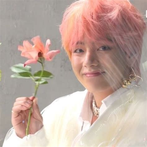 A Woman With Pink Hair Holding A Flower