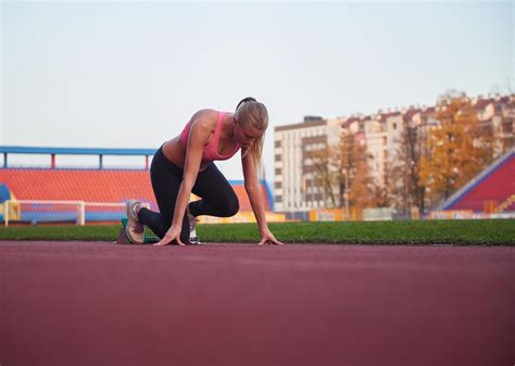 Woman Sprinter Leaving Starting Blocks 12652027 Stock Photo At Vecteezy