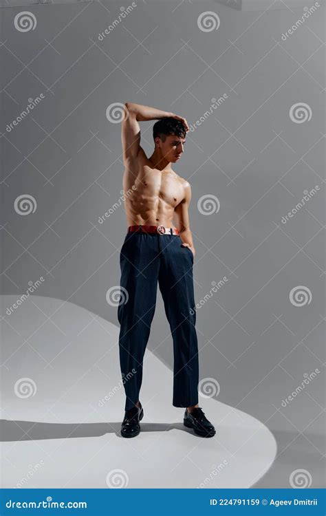 Athlete With A Pumped Up Torso Naked Torso Bodybuilder Fitness Jeans Shoes Gray Background Stock