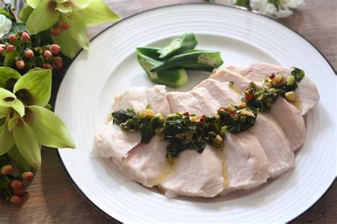 A White Plate Topped With Meat And Veggies On Top Of A Wooden Table