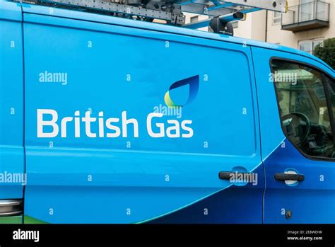 Blue British Gas (Ford Transit) van with a ladder on the roof parked in a residential area ...