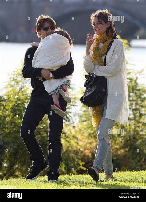 Katie Holmes Walking Beside Tom Cruise As He Carries His Daughter Suri At A Park In Cambridge