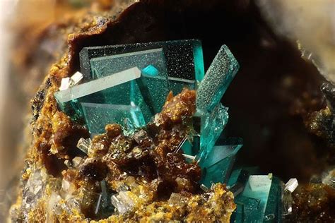 Some Very Pretty Green And Brown Crystals On Top Of Each Other In A