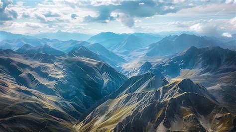 Majestic Mountain Ranges Under A Cloudy Sky Premium AI Generated Image