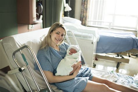 Mother With Her Newborn Baby At The Hospital A Day After A Natural