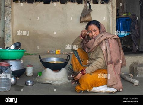 Rural Indian Woman Crying While Cooking Food In The Kitchen Using