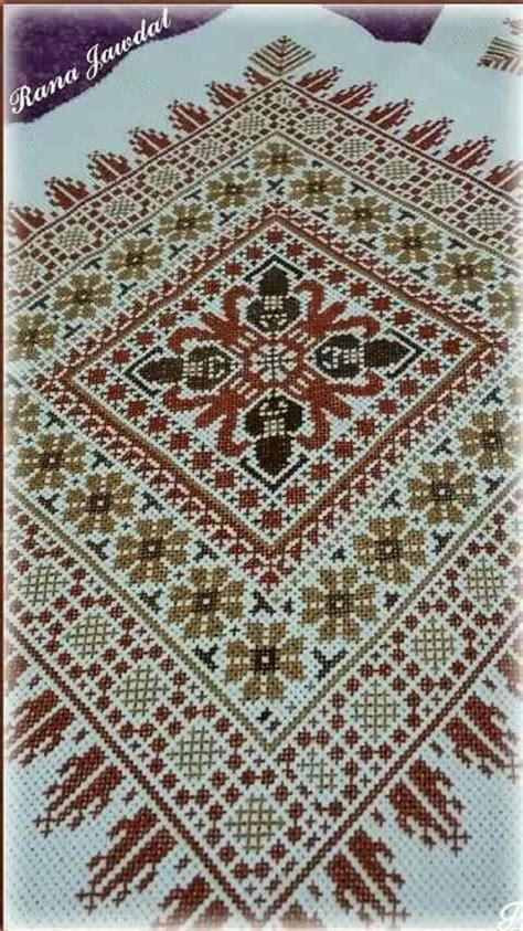 The Cross Stitch Pattern Is In Red Brown And White Colors With An