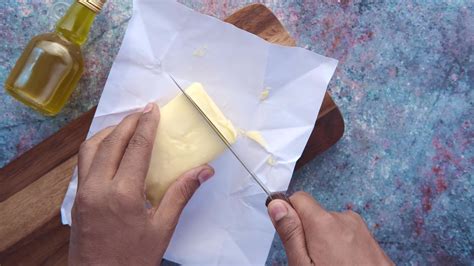 cutting butter with a knife on chopping board 23162488 Stock Video at