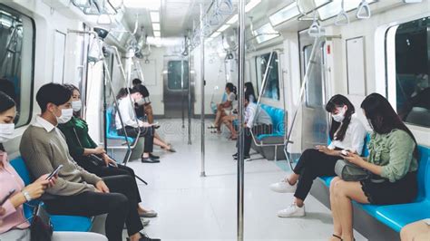 Crowd Of People Wearing Face Mask On A Crowded Public Subway Train