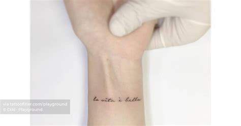 La Vita Bella Lettering Tattoo Located On The